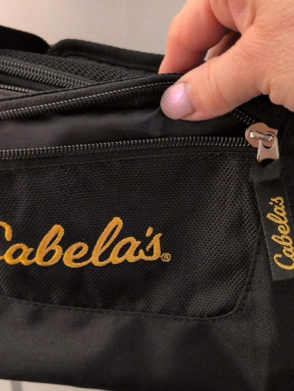Cabela's Black Duffel Bag with Gold Logo and Adjustable Strap